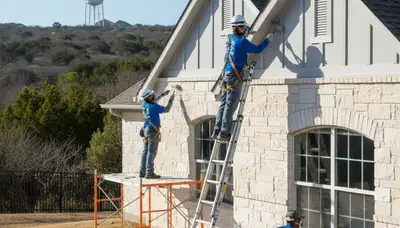Dallas TX painter applying professional interior painting service on a residential wall